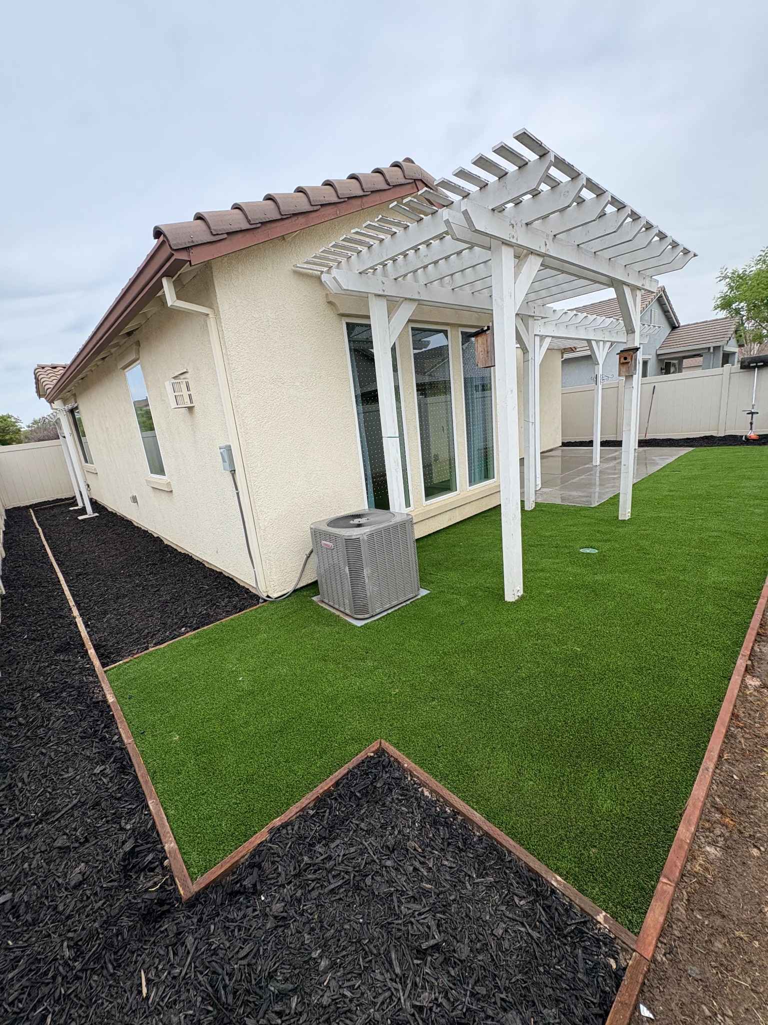 Artificial turf backyard with pergola