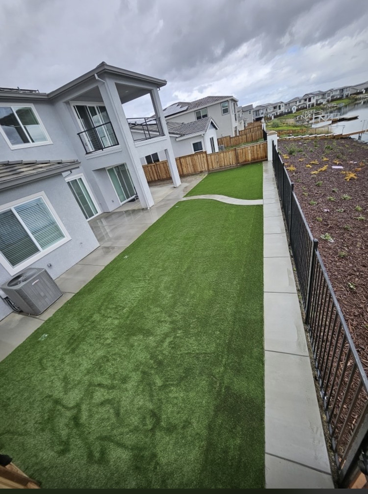 Artificial turf and concrete walkway