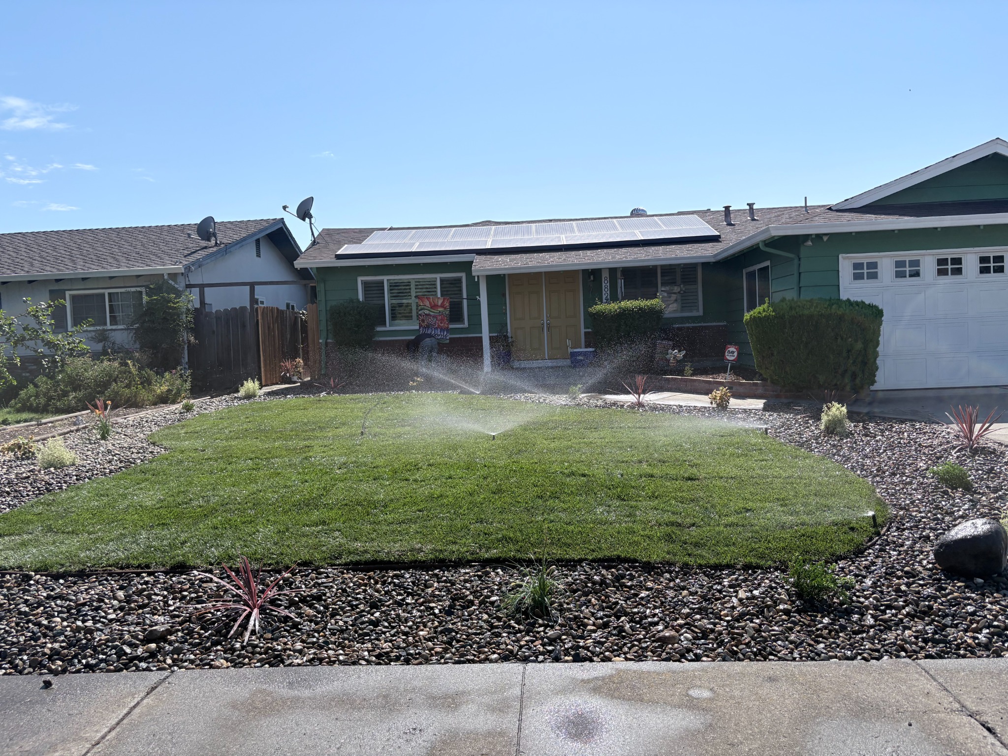 Front yard artificial turf and rock landscape