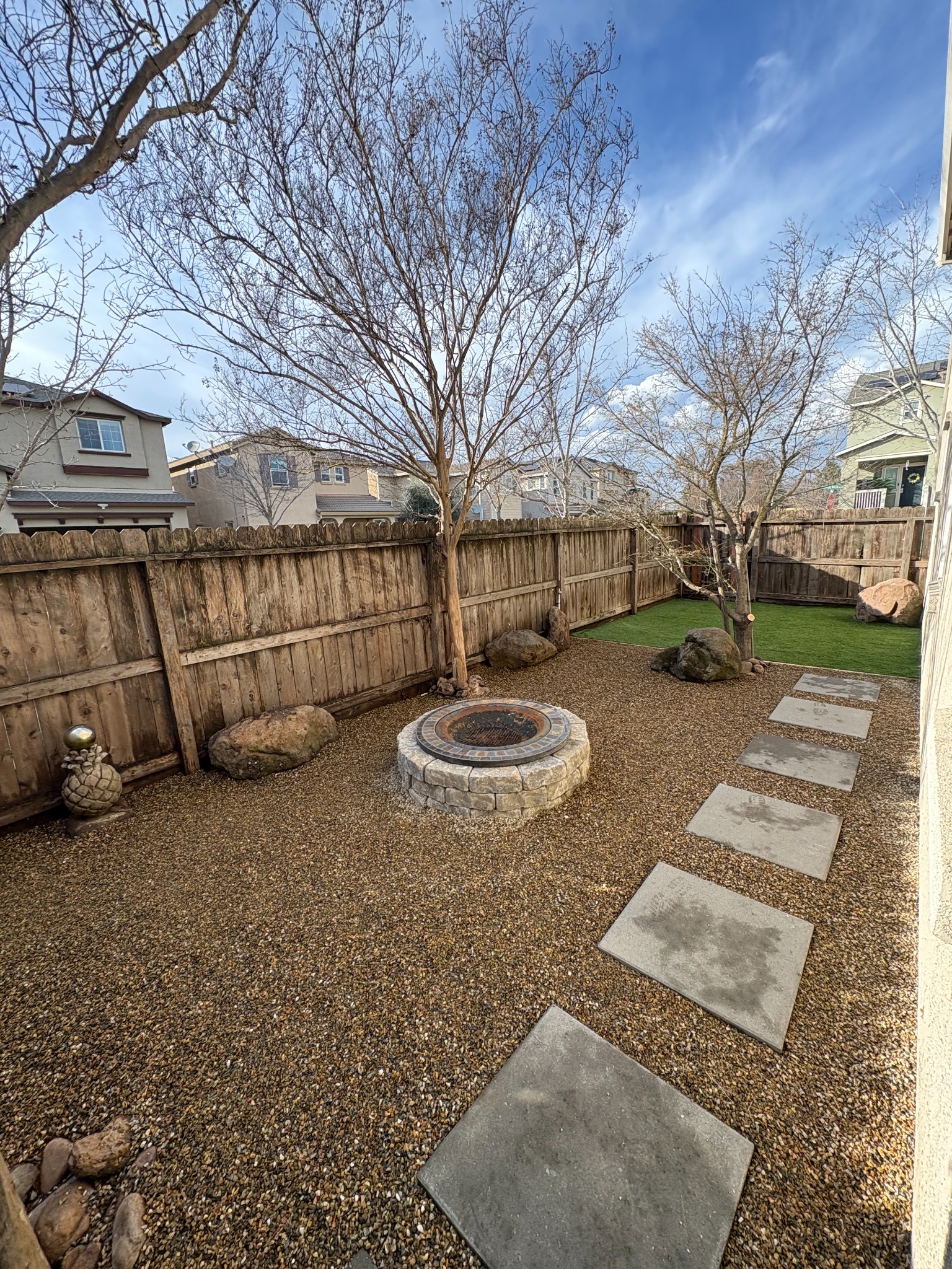Rock backyard with fire pit and stepping stones